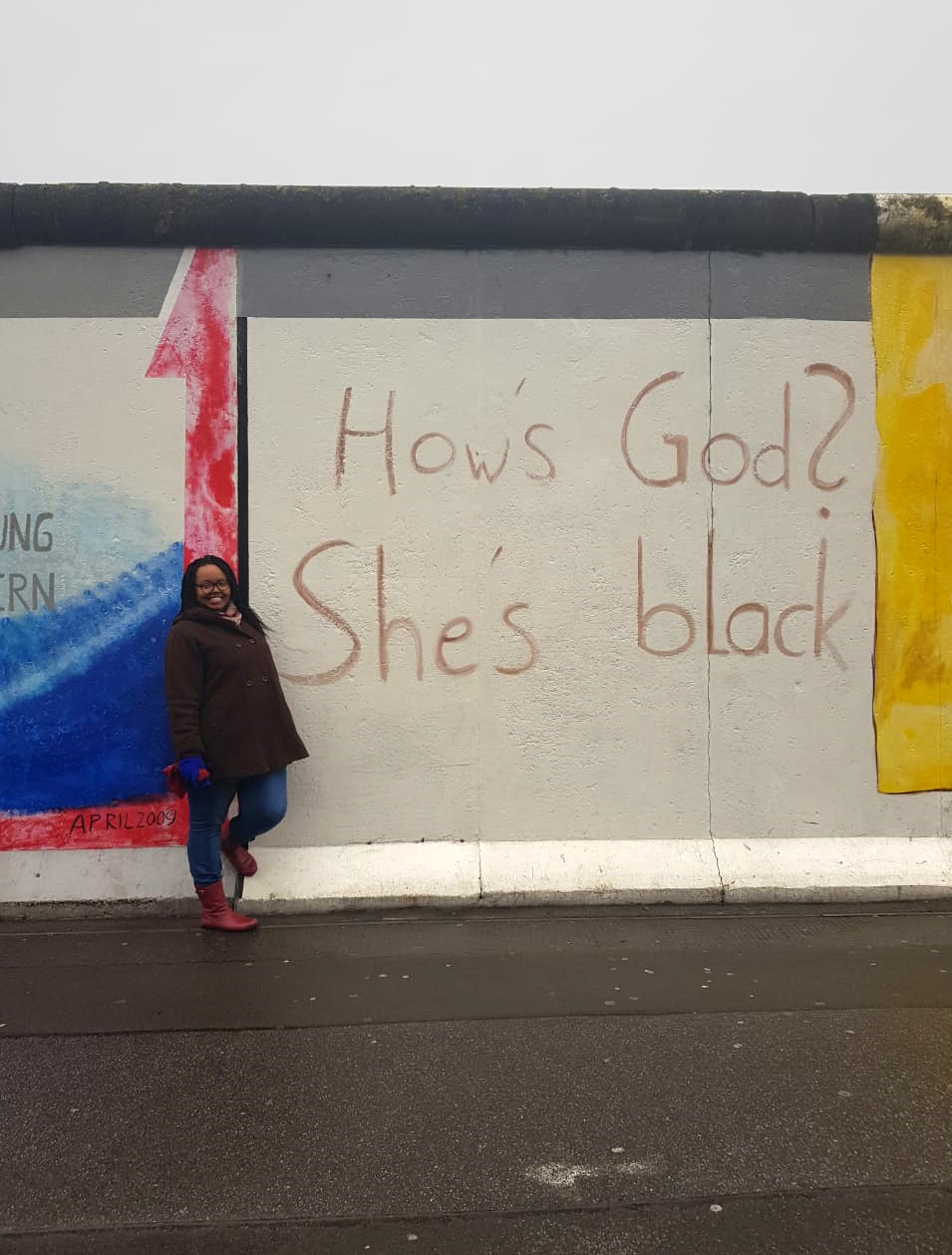Thando Ndita at one of the murals at the East Side Gallery, part of the Berlin Wall