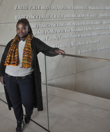 Student stands at the POLIN Museum of the History of Polish Jews