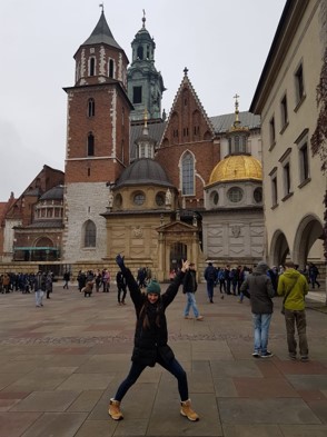 Student stands outside Wawel Castle. Krakow, Polan