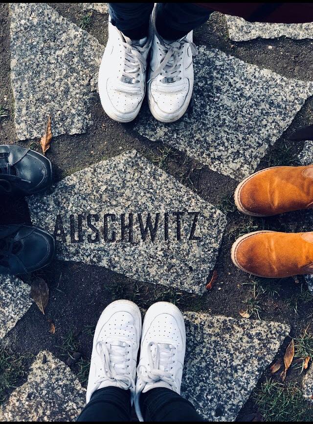 Students feet framing an Auschwitz stone