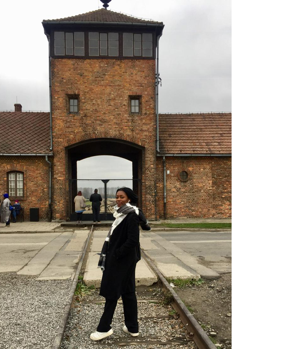 Tsegophatso Puto pictured in front of the infamous gate of Auschwitz-Birkenau.