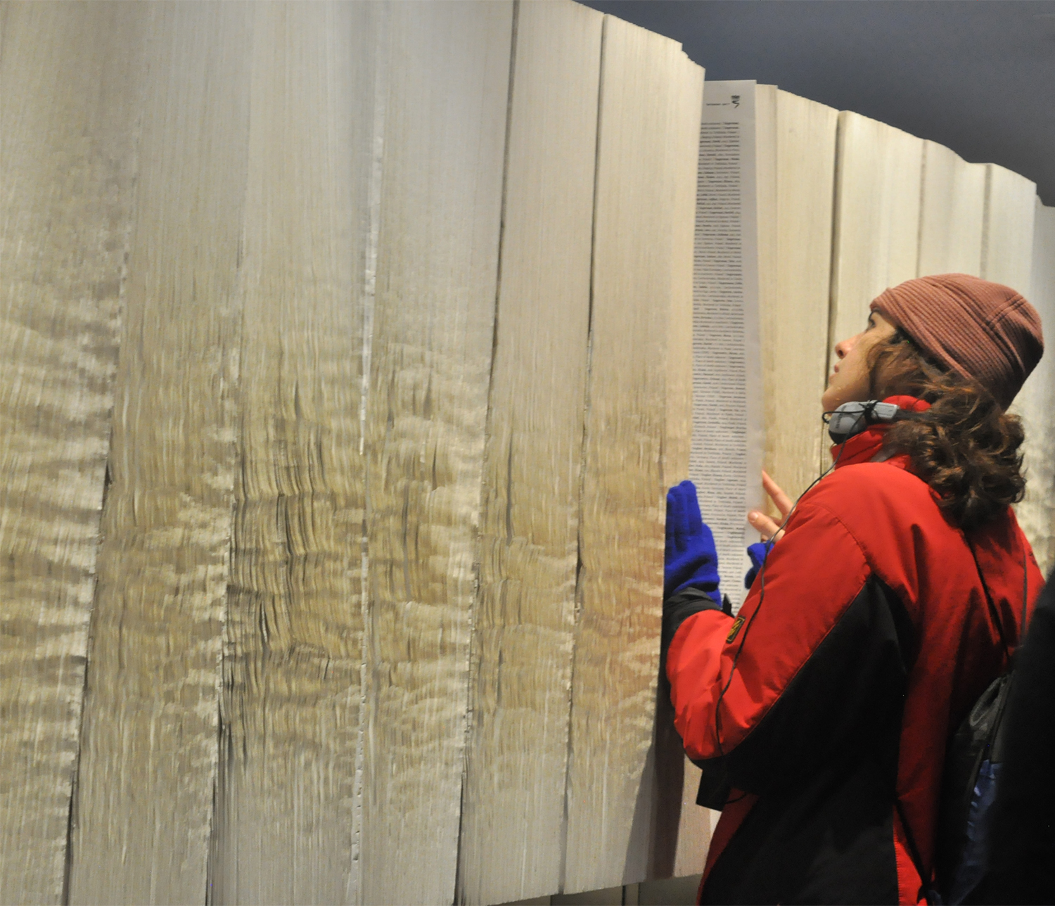 Paging through The Books of the Names of the Dead in the Auschwitz Concentration Camp’s Block 27. The books have the names of approximately four million of the six million who were murdered in the Holocaust.