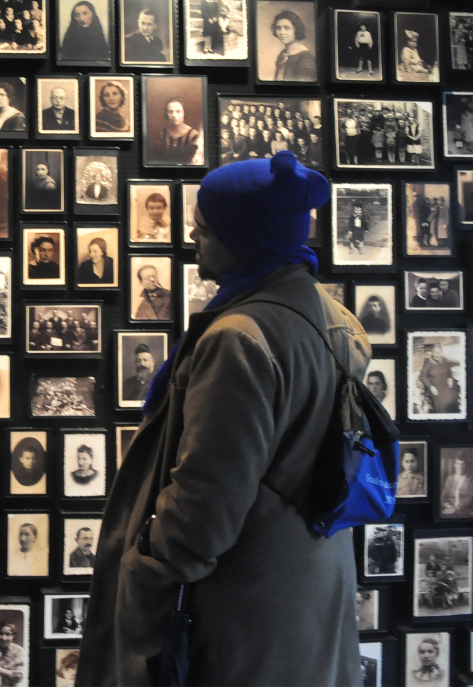 Shannon-Cupido-looking-at-pre-Holocaust-images-of-people-imprisoned-and-murdered-at-Auschwitz-Birkenau_resize