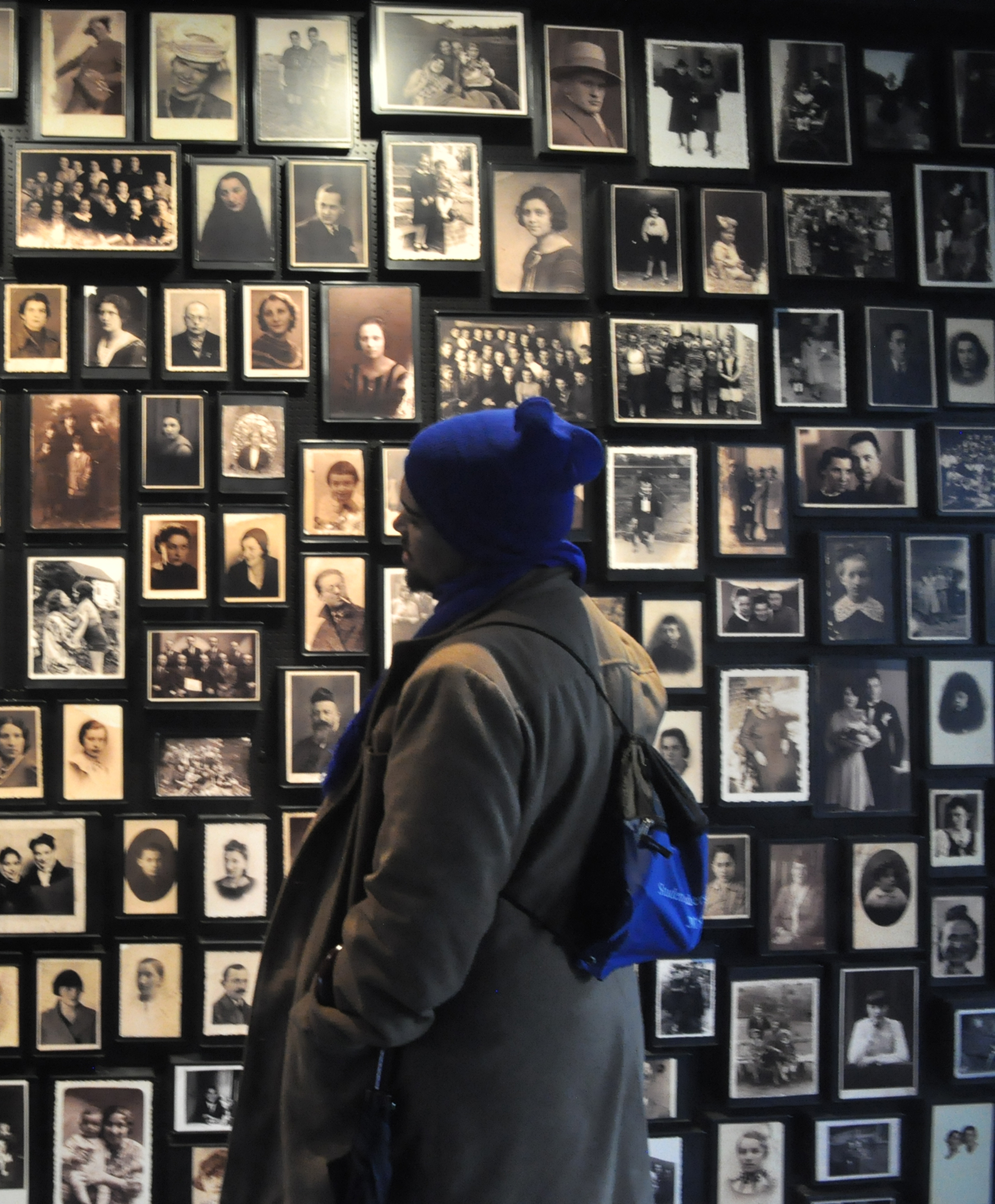 Study tour participant Shannon Cupido looking at pre-Holocaust images of people imprisoned and murdered at Auschwitz-Birkenau.